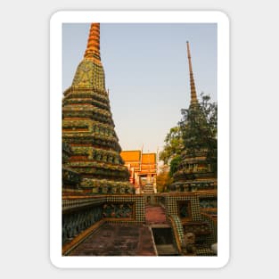 First sidewalk view to ornate roof, flanked from parts of Chedis at Wat Pho. Sticker